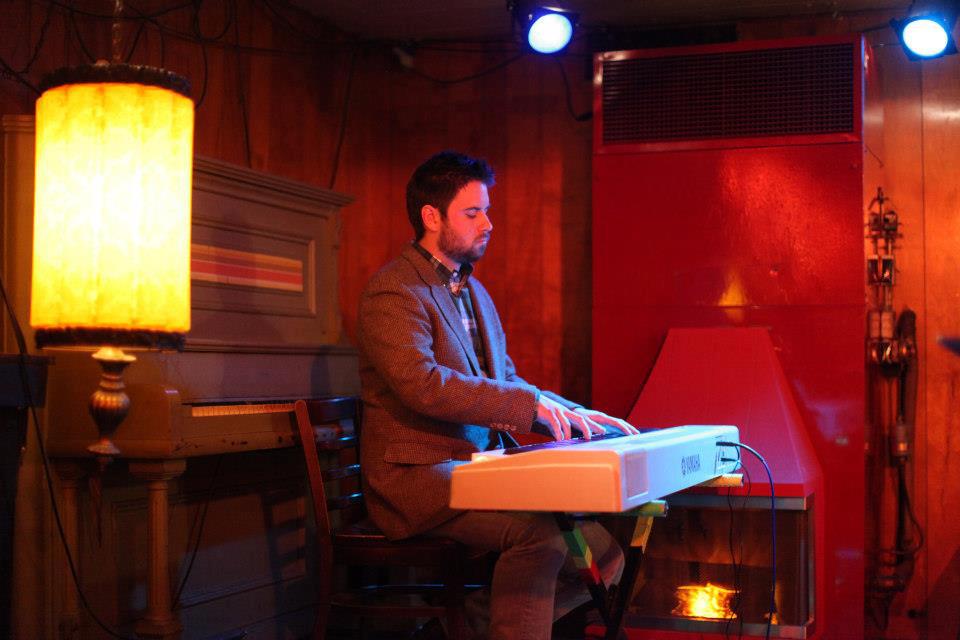 David Mercer at the piano in the January 2013 reading at the Turf Club. Photo by Sharyn Morrow, courtesy of Riot Act Reading Series.