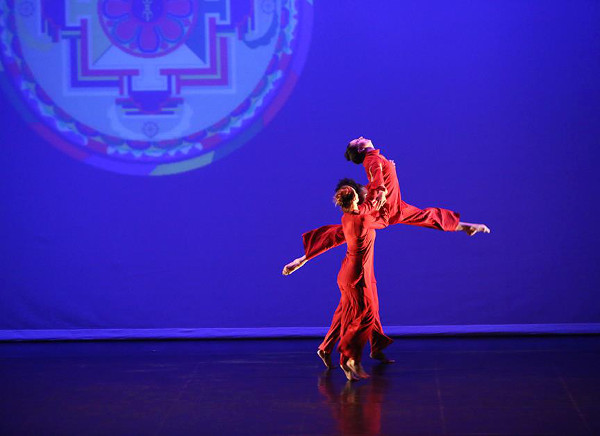 A mandala is visible beneath the leaping performers during the Kun-Yang Lin/Dancers "Mandala Project". Photo by Bill Hebert (BHPhotos).