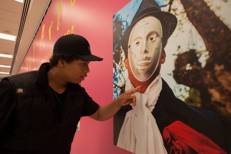 Teen artist Bernie with his portrait by Alex Heria