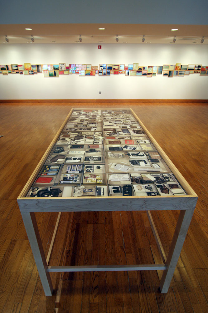 Penelope Umbrico, installation view of "Mountains, Moving" - in the foreground is “136 Mini Film Cameras in the Smithsonian Institution History of Photography Archives With Old Style Photoshop Filter." Courtesy of Bethel University galleries.