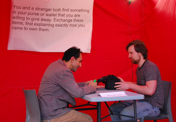 Taller Puertorriqueño's Visual Arts Manager, Rafael Damast and I exchange objects in the Proposition Tent. Photo by Justin Roman