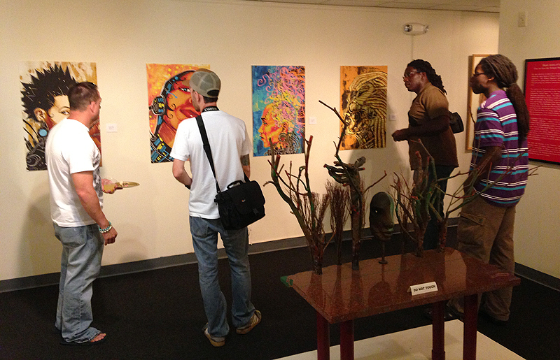 Attendees examine works by John Jennings, originally exhibited in the "Black Kirby" exhibit.