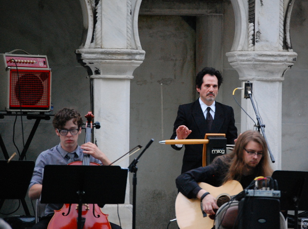 Mano Divina plays the theremin between Jonathan Salmon on cello (left) and Daniel Whitehawk on guitar (right).