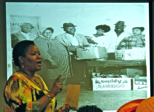 Dr. White before a slide of Fannie Lou Hamer, a civil rights activist who helped to organize one of the most successful agricultural cooperatives.
