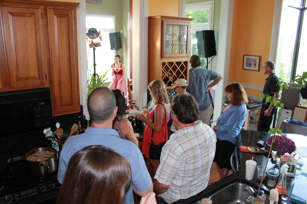 Some audience members enjoy the show from the the kitchen of the historic home where Bastian played.