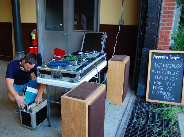 DJ Mazelov looks through his records as he spins for the attendees.