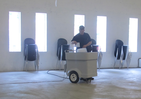 Kenyon at work with a repeat performance of his piece, "Cloud" which produces house-shaped bubbles based on housing bubble data.