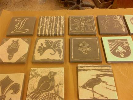 Participants carved these tiles with their own designs and they are ready to be fired.