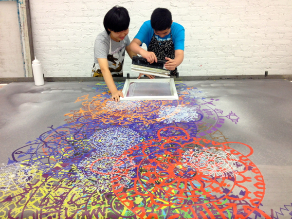 Jingwen and Benxin working hard to screen print their design on the picture. Photo courtesy emojienergy.blogspot.com