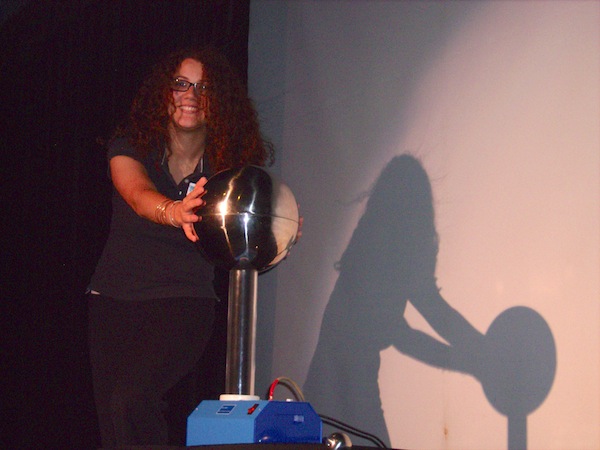 Museum Explainer Sasha Lamadrid electrifies her audience (and herself) by explaining how a Van de Graaf generator creates static electricity. 