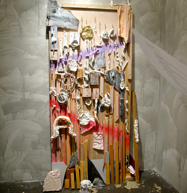 Fertility Goddess’ Survival Kit, 2013 - Cut and painted wood, found objects, aluminum foil, foam, plaster, spray paint,  dyed lace, gouache, hooks, ball chain, painter’s rag, latex paint on wall.
