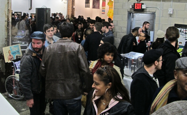 The opening night crowd down at basement level, where most of the work is on display.