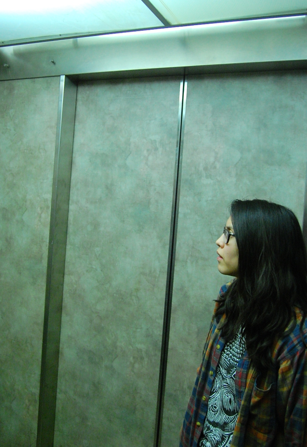 Yowei Shaw listens to an audio test in the elevator.