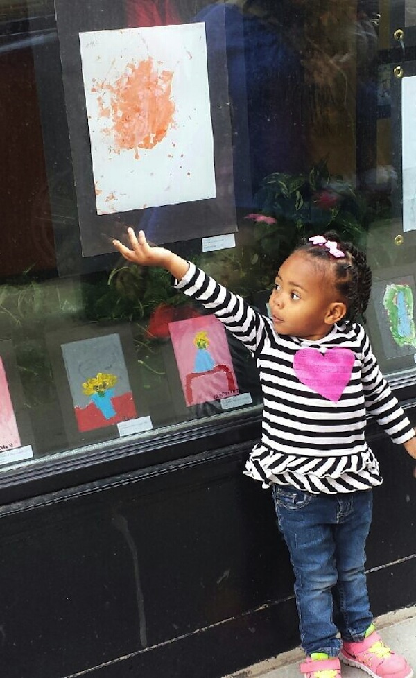 Moriah, age 2 finds her art work on display during the 2014 ARTwalk.