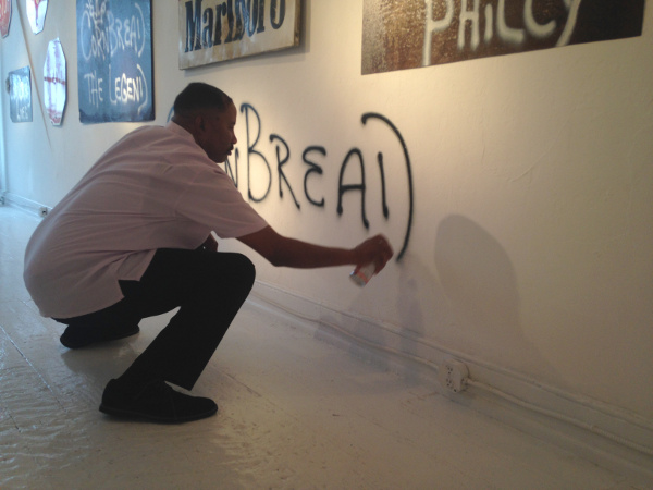 Darryl "Cornbread" McCray tagging the James Oliver Gallery wall. Image courtesy Sara McCorriston