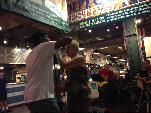 Instructor-choreographer Marck “Flaco” Best dances with a Market patron  