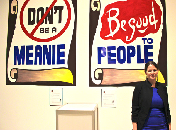 Artist Corrie Baldauf, with a pair of her signature signs.