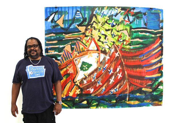 Saffell Gardner poses next to "Lost Kings," a reflection on the Middle Passage and slave trade.