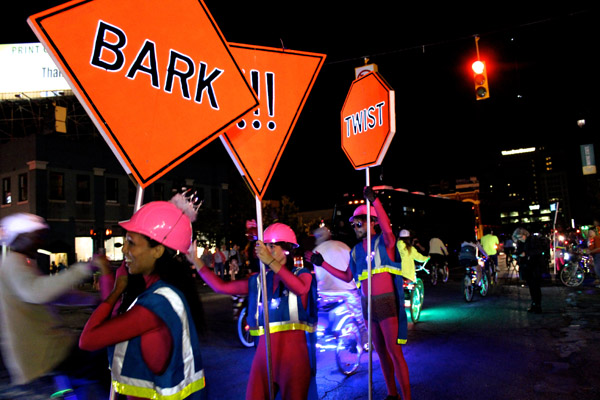 Illuminated signs with some unorthodox directions lined the Light Bike Parade route.