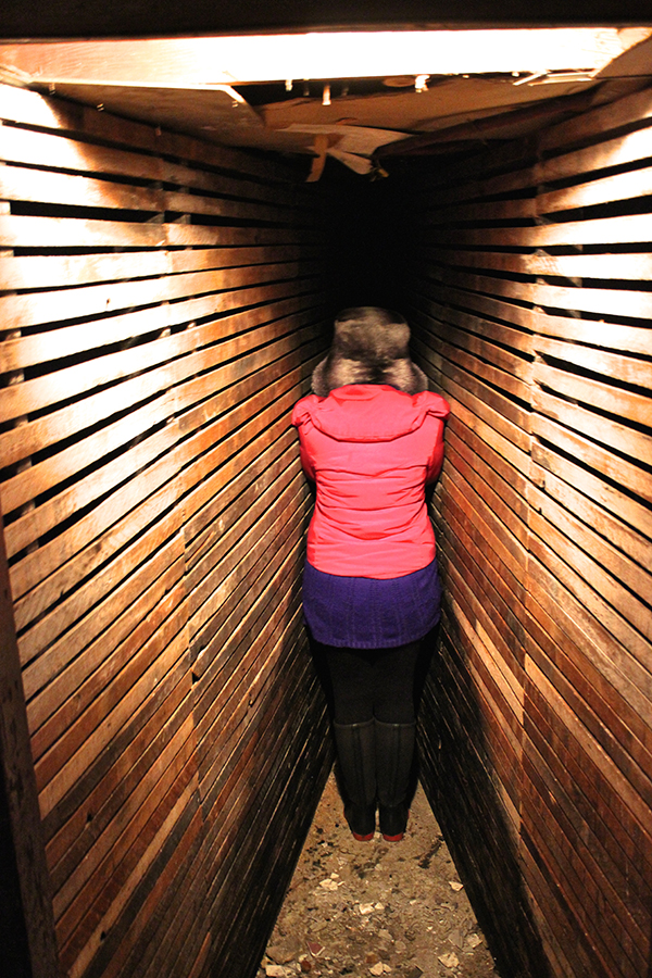 Artist Corrie Baldauf braves the infinity room installation, wedging herself into the vanishing point of the room.
