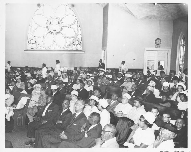 One black and white photographic print showing the congregation at the Second Baptist Church at 188 E. Center Street in Akron, Ohio.  The congregation at Second Baptist Church located on East Center Street in Akron gathers to listen to a sermon.