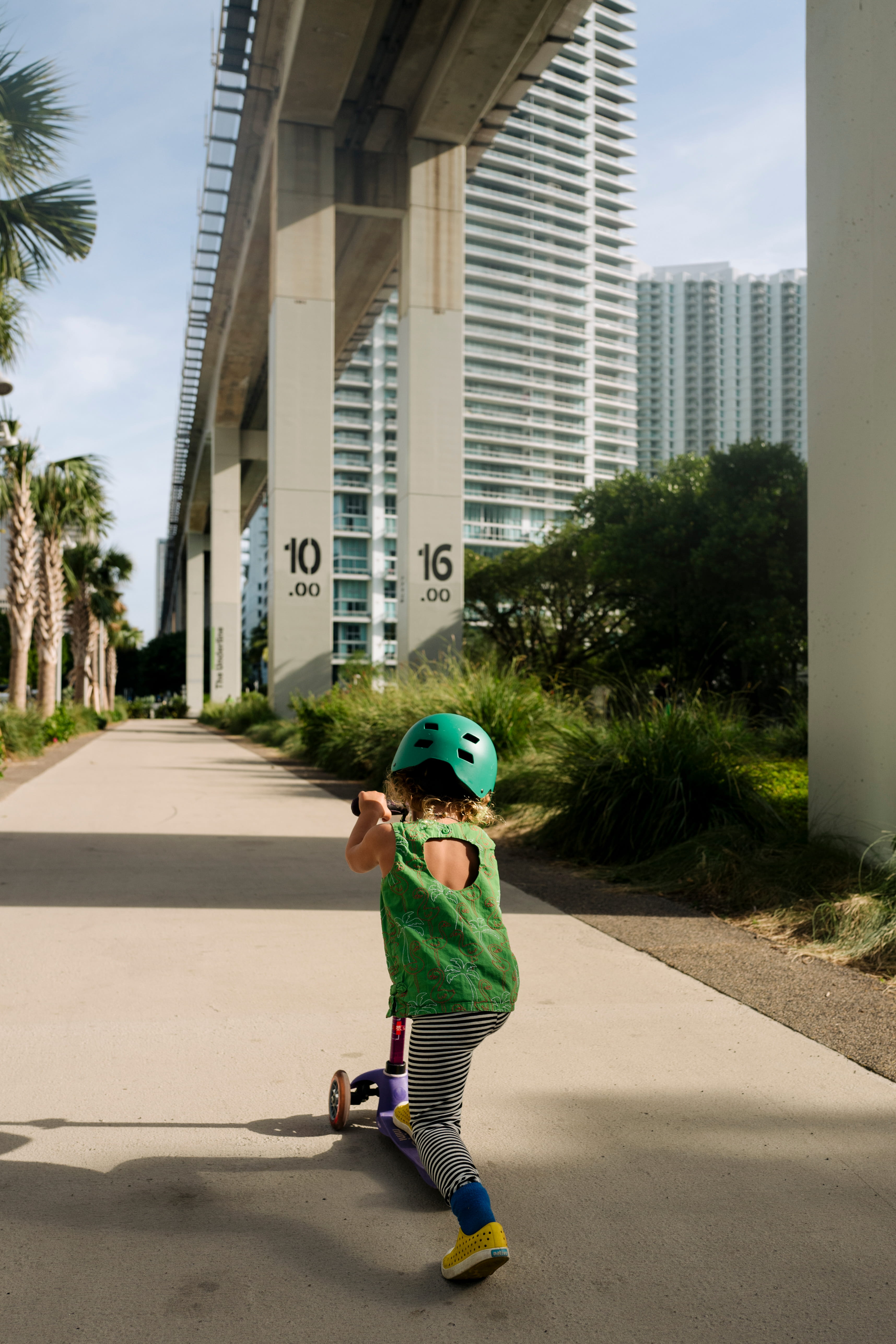 Girl riding a scooter photo.