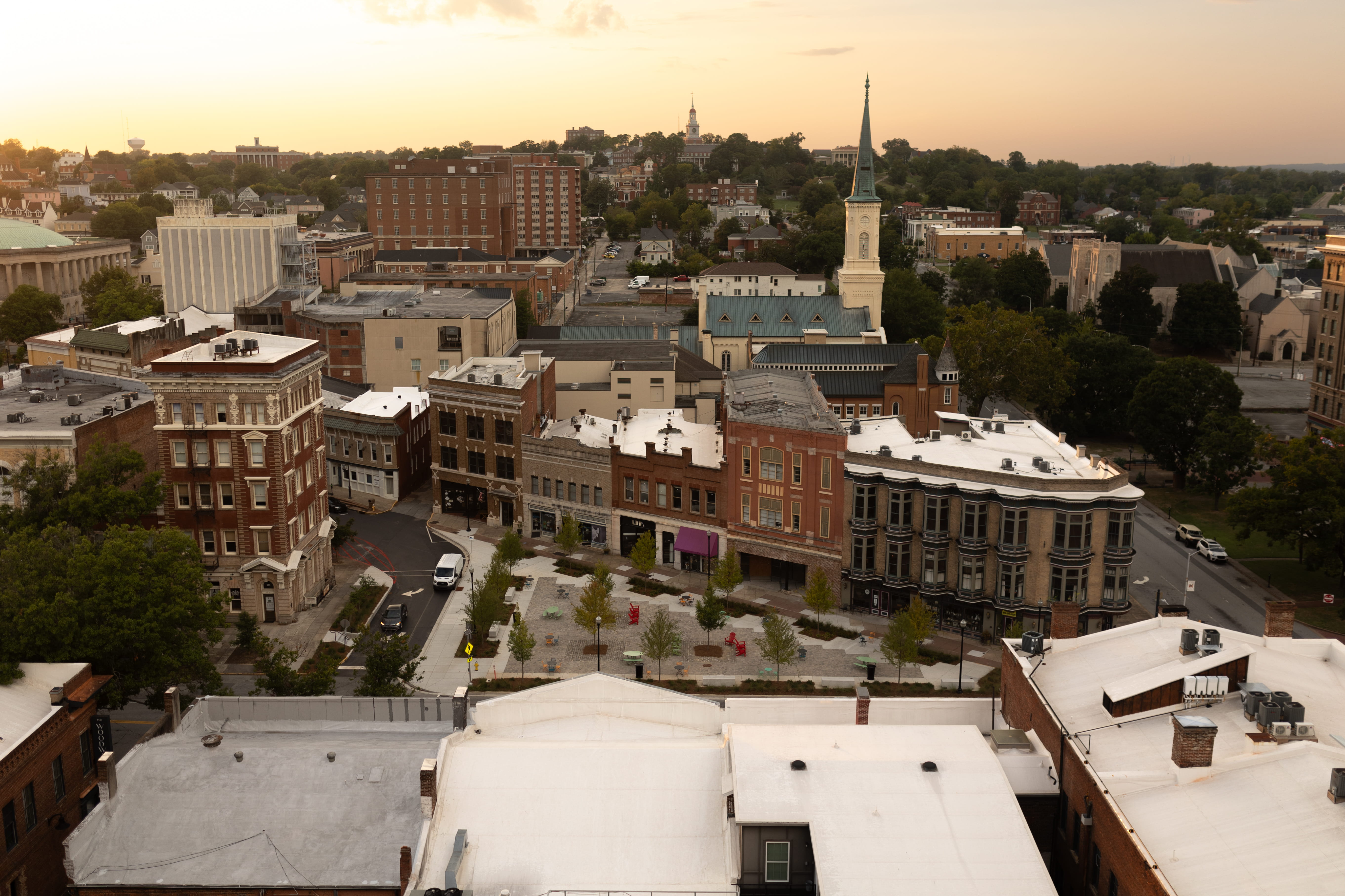 Aerial view of downtown Macon showing buildings, a plaza and a church.