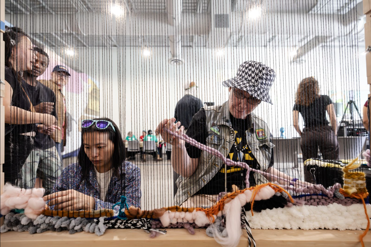 Community weaving at Springboard for the Arts in Saint Paul, MN. Photo by Thaiphy Phan-Quang, 2025.